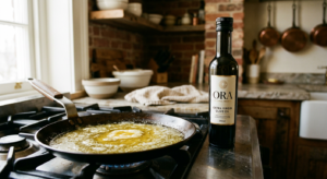 A professional, editorial-style closeup shot of a kitchen pan on a stove featuring a golden pool of